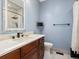 Bathroom with marble countertop, dark wood cabinets and a glass enclosed shower at 1505 Castlecombe Ln, Monument, CO 80132
