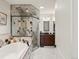 Bathroom featuring a soaking tub, shower and dual vanity with elegant finishes and fixtures at 1505 Castlecombe Ln, Monument, CO 80132