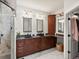 Bathroom with double sinks, dark wood cabinets, and a luxurious marble-tiled shower stall at 1505 Castlecombe Ln, Monument, CO 80132