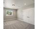 Bedroom boasting a window with a view and double doors, creating a peaceful and inviting retreat at 1505 Castlecombe Ln, Monument, CO 80132