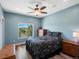 Cozy bedroom with natural light from window, dark floral bedspread, and wood dresser at 1505 Castlecombe Ln, Monument, CO 80132