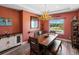 Dining room with rustic wood table, antler chandelier and a window with a picturesque view at 1505 Castlecombe Ln, Monument, CO 80132