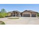 Home with a circular driveway, three-car garage, stone accents, and a basketball hoop for outdoor fun at 1505 Castlecombe Ln, Monument, CO 80132