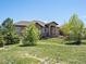 Charming home with a stone facade, covered entryway, and beautifully landscaped front yard at 1505 Castlecombe Ln, Monument, CO 80132