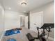 A well-lit home gym with a stationary bike and various exercise equipment on the carpeted floor at 1505 Castlecombe Ln, Monument, CO 80132