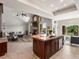 Open-concept kitchen featuring a center island with a sink and views of the fireplace and living room at 1505 Castlecombe Ln, Monument, CO 80132