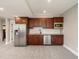 Basement kitchenette featuring wood cabinetry, stainless steel appliances, and granite countertops at 1505 Castlecombe Ln, Monument, CO 80132