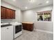 Laundry room features a front load washer and dryer, wood cabinets and carpet at 1505 Castlecombe Ln, Monument, CO 80132