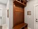 Mud room showcasing a convenient wooden storage unit with hooks, shelves, and a built-in bench at 1505 Castlecombe Ln, Monument, CO 80132