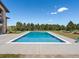 A luxurious in-ground pool with surrounding greenery and a beautiful lawn for outdoor relaxation at 1505 Castlecombe Ln, Monument, CO 80132