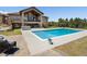 Beautiful backyard features a private pool, hot tub, and patio seating, perfect for outdoor entertaining at 1505 Castlecombe Ln, Monument, CO 80132