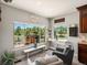Inviting sitting area filled with natural light from large windows offering views of the home's serene landscape at 1505 Castlecombe Ln, Monument, CO 80132