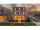 Inviting two-story home with a covered porch and balcony overlooking a well-manicured lawn at 2843 Havana St, Denver, CO 80238