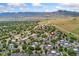 Expansive aerial view showcasing the community with mountain backdrop and ample parking at 1670 S Deframe St # B2, Lakewood, CO 80228