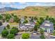 Scenic aerial view showing lush landscaping, mature trees, and mountain views surrounding this lovely community at 1670 S Deframe St # B2, Lakewood, CO 80228