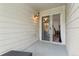 Outdoor balcony with white siding featuring a sliding glass door entry at 1670 S Deframe St # B2, Lakewood, CO 80228