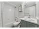 Bright bathroom with clean white tile and modern fixtures, including a shower-tub combo at 1670 S Deframe St # B2, Lakewood, CO 80228