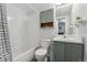 Well-maintained bathroom with shower-tub, light gray vanity, and a wall cabinet for storage at 1670 S Deframe St # B2, Lakewood, CO 80228