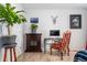 Bedroom with a fireplace, desk area, large plant, and wall decor at 1670 S Deframe St # B2, Lakewood, CO 80228