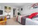 Inviting bedroom with ample light, a wood desk, and neutral carpet throughout the space at 1670 S Deframe St # B2, Lakewood, CO 80228