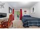 Bright bedroom featuring a sliding glass door to the balcony and neutral carpeting at 1670 S Deframe St # B2, Lakewood, CO 80228