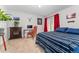 Comfortable bedroom featuring a fireplace, built-in shelves, and a desk area, with ample sunlight at 1670 S Deframe St # B2, Lakewood, CO 80228