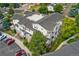 Exterior aerial view showcasing a condo building with multiple balconies and ample parking at 1670 S Deframe St # B2, Lakewood, CO 80228