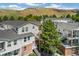 Exterior view of condos with brick accents, exterior stairs, and well-maintained landscaping at 1670 S Deframe St # B2, Lakewood, CO 80228