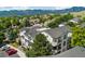 An exterior view of a condo building with multiple balconies and views of surrounding greenery and mountains at 1670 S Deframe St # B2, Lakewood, CO 80228