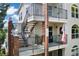 Charming condo complex with brick accents, multiple balconies, and stairwell access to each level at 1670 S Deframe St # B2, Lakewood, CO 80228