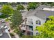Exterior view of a three-story condo with balconies, featuring wrought iron railings and lush surroundings at 1670 S Deframe St # B2, Lakewood, CO 80228