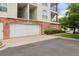 Attached garage with brick facade offering convenient parking at 1670 S Deframe St # B2, Lakewood, CO 80228