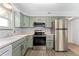 Well-lit kitchen features stainless steel appliances, light countertops, and plentiful cabinet space at 1670 S Deframe St # B2, Lakewood, CO 80228
