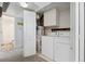Clean laundry room with modern washer and dryer next to a water heater and partial bathroom view at 1670 S Deframe St # B2, Lakewood, CO 80228