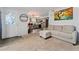 Inviting living room boasts a gray sofa, colorful artwork, modern lighting and luxury vinyl plank flooring at 1670 S Deframe St # B2, Lakewood, CO 80228