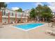 Community pool surrounded by lounge chairs and well-maintained landscaping at 1670 S Deframe St # B2, Lakewood, CO 80228
