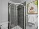 Modern bathroom featuring gray tiled shower with glass door and unique wall art at 6844 Countryside Ln # 284, Niwot, CO 80503