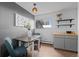 Cozy dining area with modern light fixture, gray cabinets, and floating shelves is ideal for meals and entertaining at 6844 Countryside Ln # 284, Niwot, CO 80503
