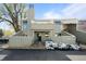 Inviting two-story condo boasts a charming exterior with a small fenced yard and light green siding at 6844 Countryside Ln # 284, Niwot, CO 80503