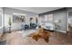 Bright living room with hardwood floors, two large windows, a white couch, and gray accent wall is ideal for relaxation at 6844 Countryside Ln # 284, Niwot, CO 80503