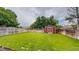 Spacious backyard with green grass, a shed, and a privacy fence at 12201 N Holly Way, Brighton, CO 80602