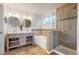 Bathroom featuring a vanity with dual sinks and a shower at 12201 N Holly Way, Brighton, CO 80602