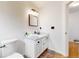 Bright bathroom featuring a white vanity with modern fixtures and neutral walls at 12201 N Holly Way, Brighton, CO 80602
