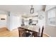 Bright and airy dining area featuring stainless steel appliances and a central table at 12201 N Holly Way, Brighton, CO 80602