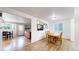 Open-concept dining room featuring hardwood floors and natural light at 12201 N Holly Way, Brighton, CO 80602