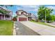 Exterior view of a two-story home with a well-manicured lawn and ample driveway space at 12201 N Holly Way, Brighton, CO 80602