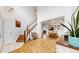 Spacious foyer featuring hardwood floors, stairs to the upper level, and an open view to the dining area at 12201 N Holly Way, Brighton, CO 80602