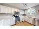 Modern kitchen boasting stainless steel appliances, white cabinets, and quartz countertops at 12201 N Holly Way, Brighton, CO 80602
