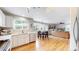 Modern kitchen open to the living room with stainless steel appliances and a breakfast nook at 12201 N Holly Way, Brighton, CO 80602
