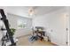 Modern office with a dark wood desk, ceiling fan, and shelving unit at 12201 N Holly Way, Brighton, CO 80602